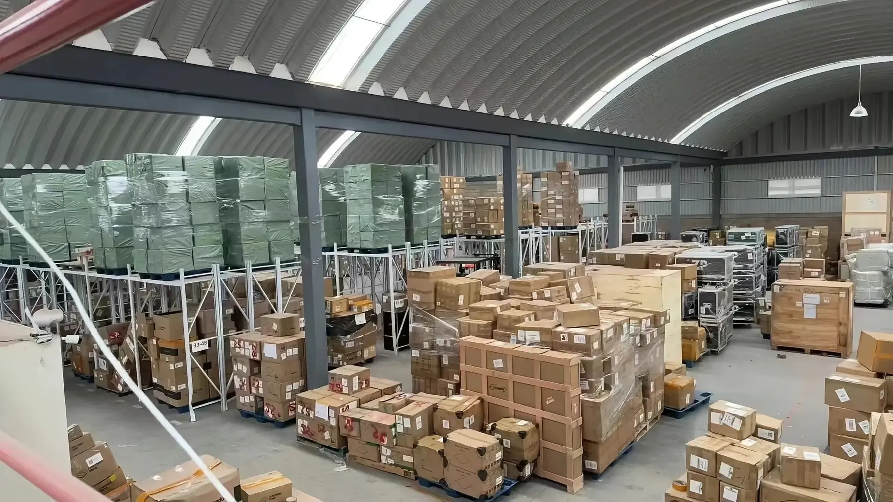 Large Shenzhen warehouse floor stacked with pallets of Amazon FBA inventory ready for prep